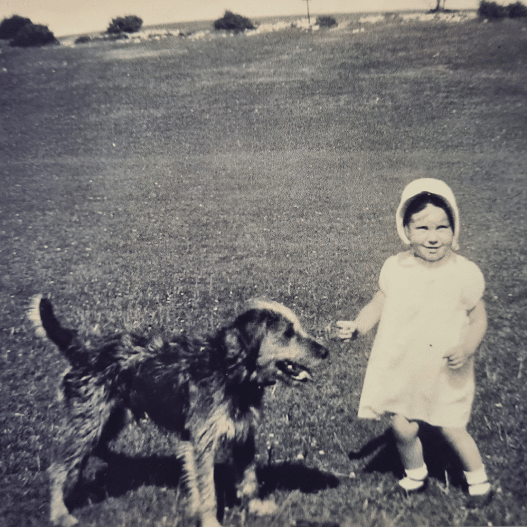 Margaret as a child, playing with a dog