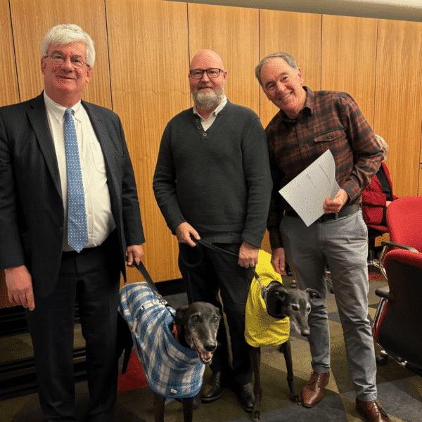 Saul Eslake, Dogs' Homes CEO Mark Wild and 'end taxpayer funding of greyhound racing' campaign ambassador Peter Gee.