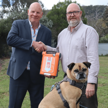 St John Ambulance Tasmania CEO Andrew Paynter, left, with Dogs’ Homes CEO Mark Wild and Dudley, who has been adopted